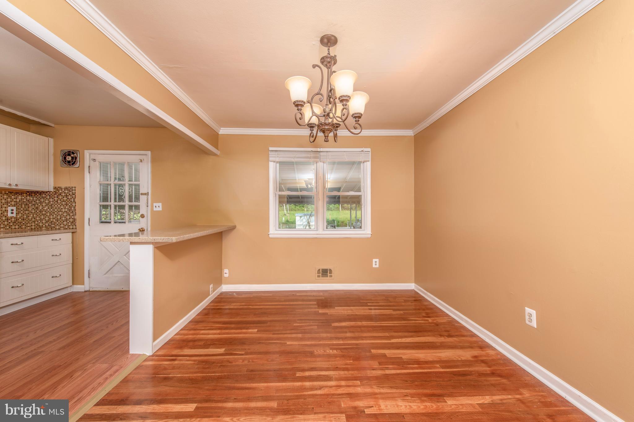 5607 Whitby Road Baltimore, MD 21206 - Photo 6 of 20 a view of a room with wooden floor and window
