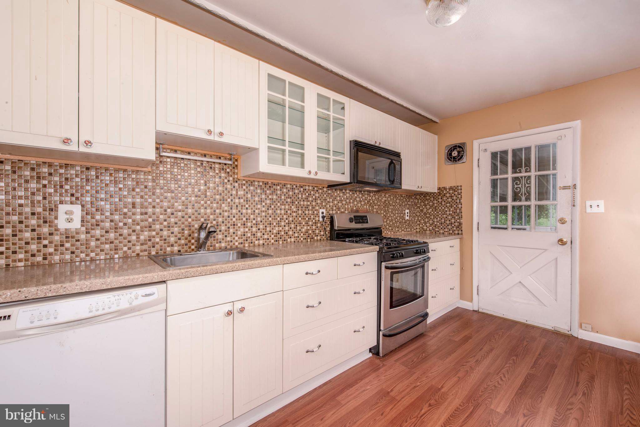 5607 Whitby Road Baltimore, MD 21206 - Photo 8 of 20 a kitchen with granite countertop white cabinets and stainless steel appliances