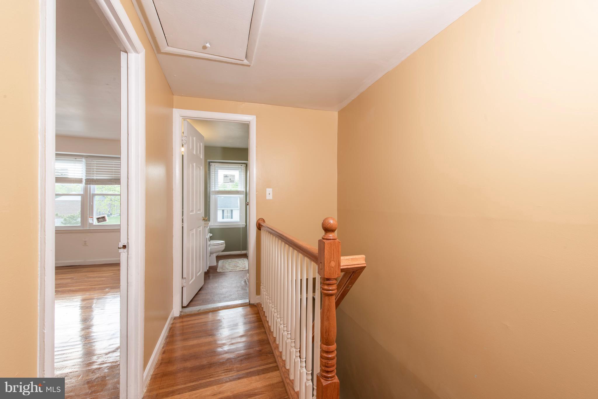 5607 Whitby Road Baltimore, MD 21206 - Photo 9 of 20 a view of a hallway with wooden floor and staircase