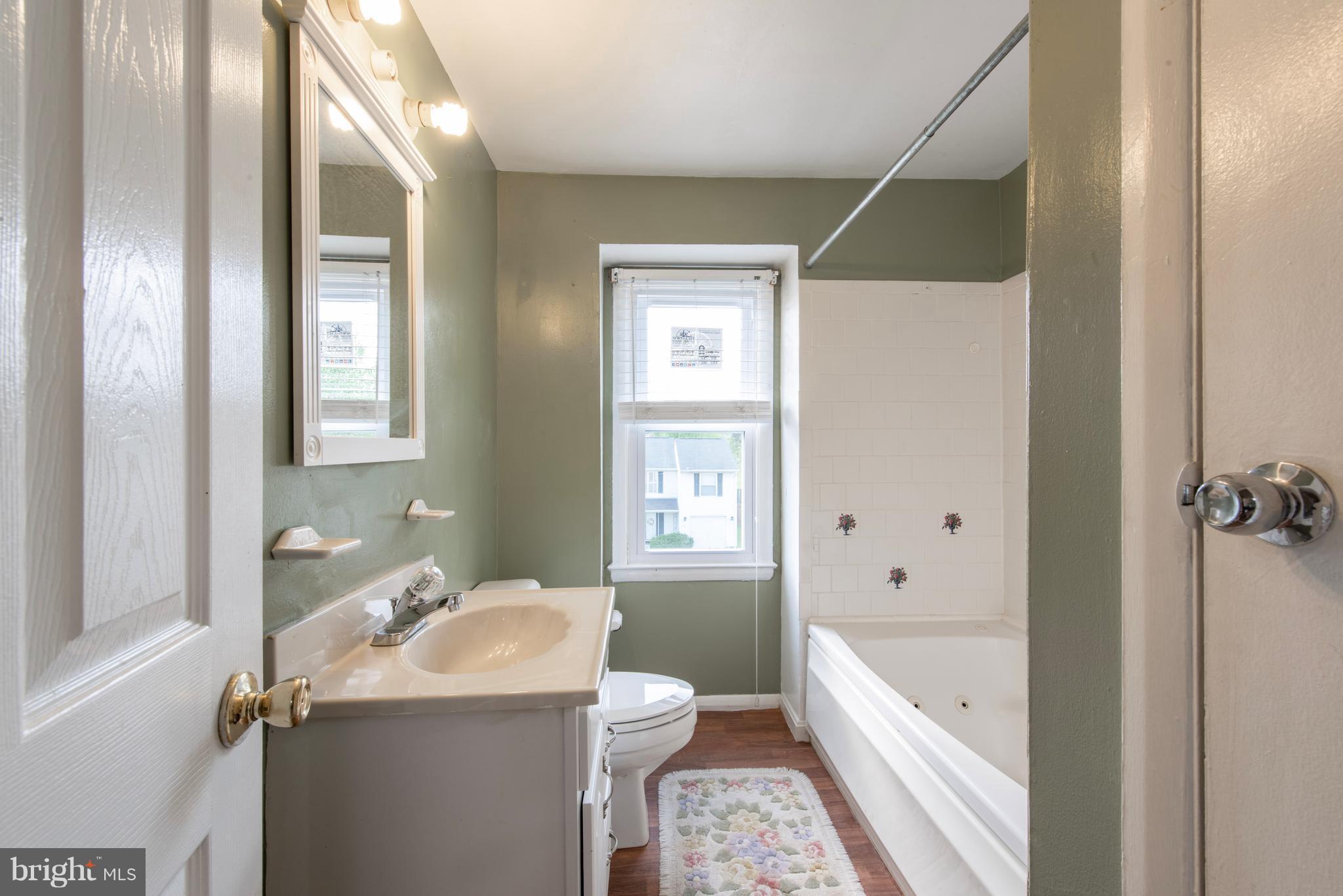 5607 Whitby Road Baltimore, MD 21206 - Photo 10 of 20 a bathroom with a granite countertop sink toilet and shower
