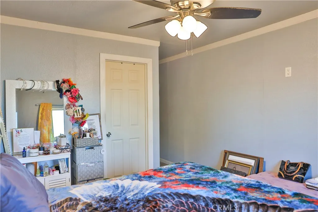 10825 Paskenta Road Red Bluff, CA 96080 - Photo 11 of 42 a bedroom with a bed and a chandelier