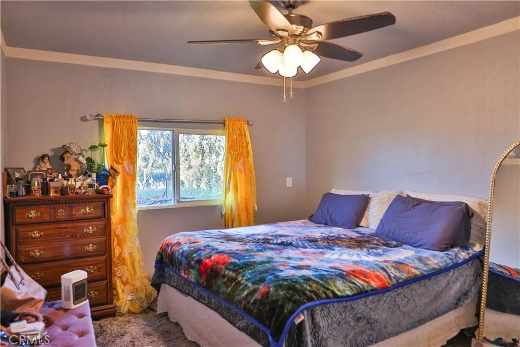 10825 Paskenta Road Red Bluff, CA 96080 - Photo 12 of 42 a bedroom with a bed and a window