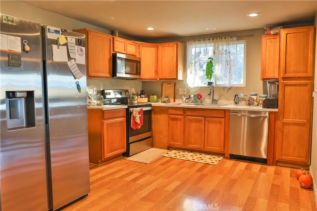 10825 Paskenta Road Red Bluff, CA 96080 - Photo 27 of 42 a kitchen with stainless steel appliances granite countertop a sink counter space cabinets and a large window
