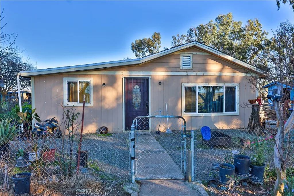 10825 Paskenta Road Red Bluff, CA 96080 - Photo 31 of 42 a front view of house with yard outdoor seating and barbeque oven