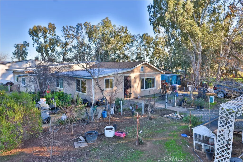 10825 Paskenta Road Red Bluff, CA 96080 - Photo 4 of 42 a front view of a house with a yard fire pit and outdoor seating