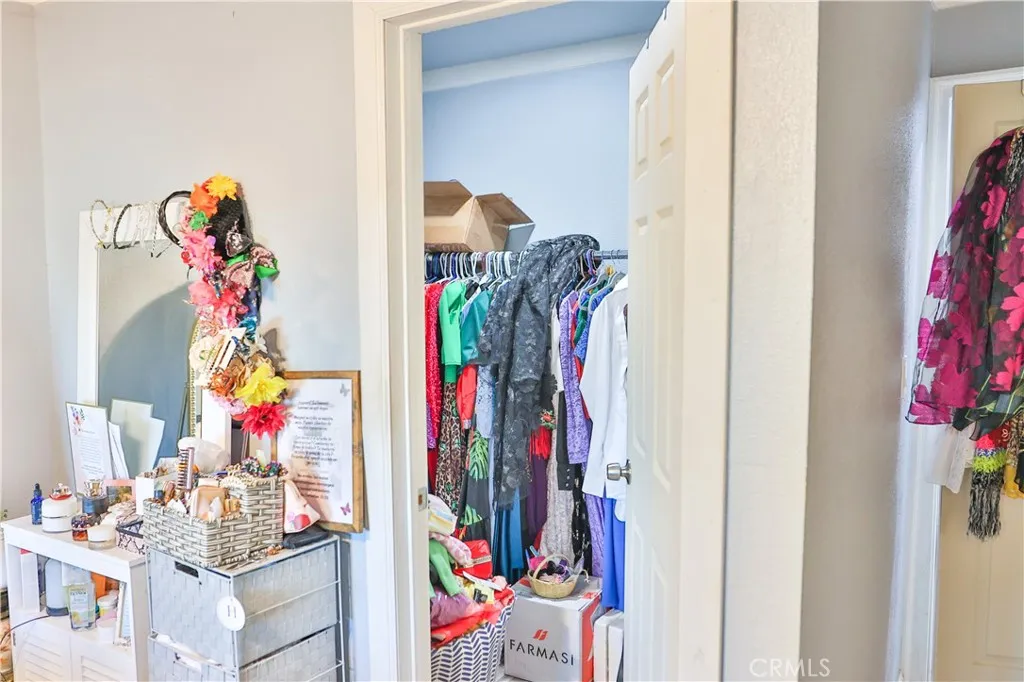 10825 Paskenta Road Red Bluff, CA 96080 - Photo 9 of 42 a view of walk in closet with clothes shoes and a chandelier