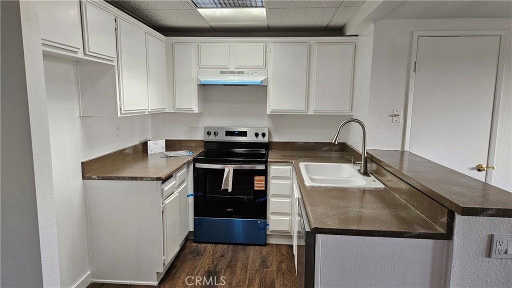 1400 West Edgehill Road, Unit 24 San Bernardino, CA 92405 - Photo 6 of 6 a kitchen with a sink a stove and cabinets