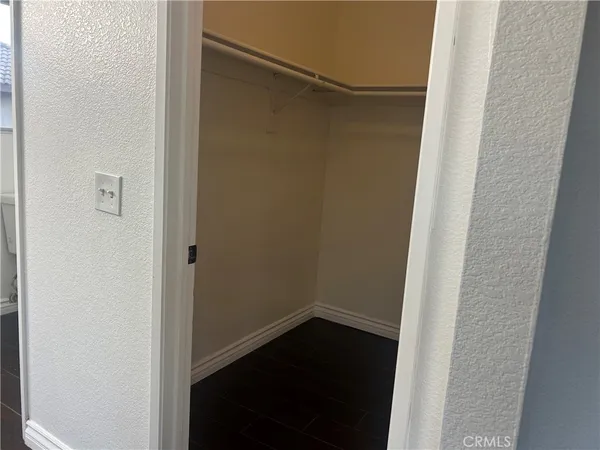 an empty room with wooden floor and closet