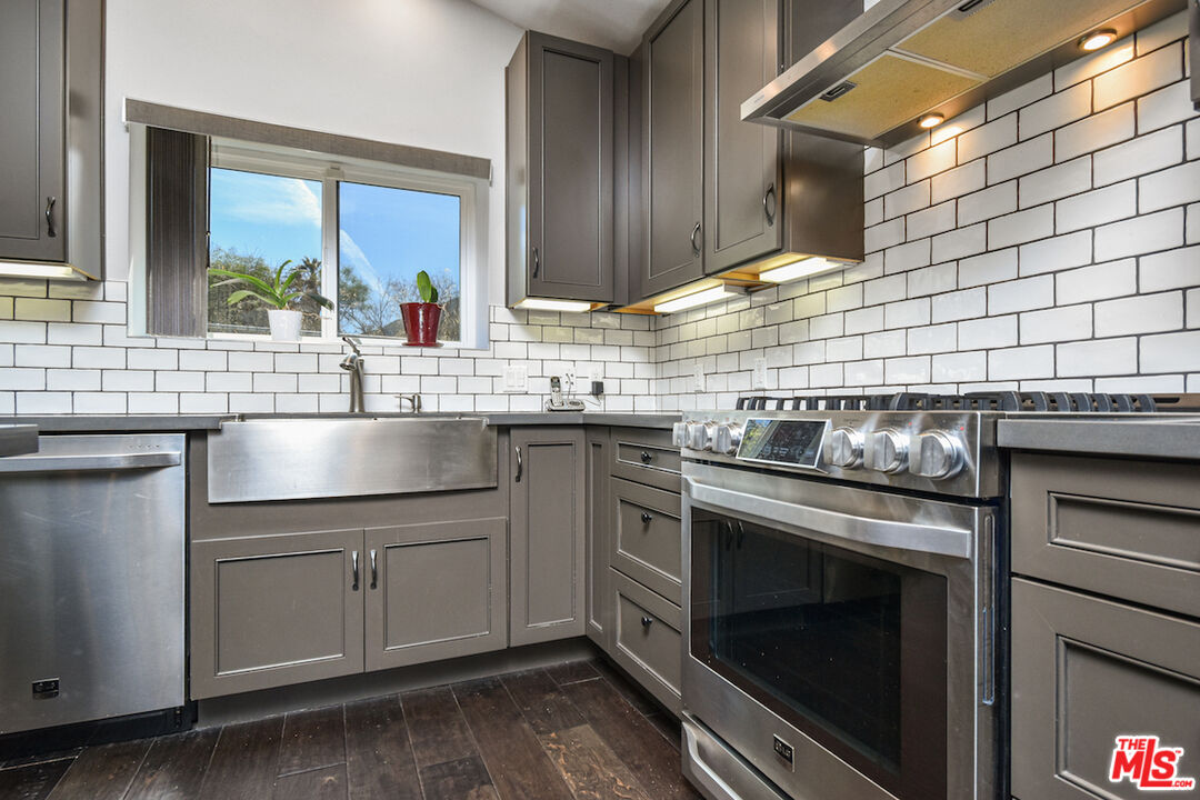 2447 Stonyvale Road Tujunga, CA 91042 - Photo 6 of 33 a kitchen with a sink stove and cabinets