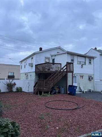 a view of a house with a backyard and a patio