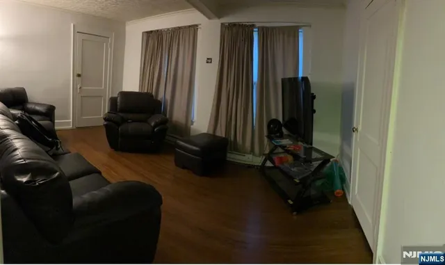 a living room with furniture rug and a window