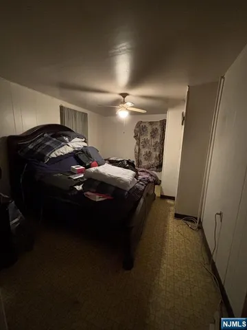 a bed sitting in a room next to a lamp