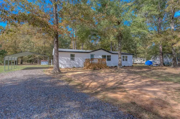 a front view of house with yard and trees