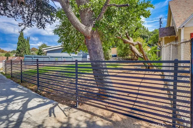 a view of a street with a tree in the background