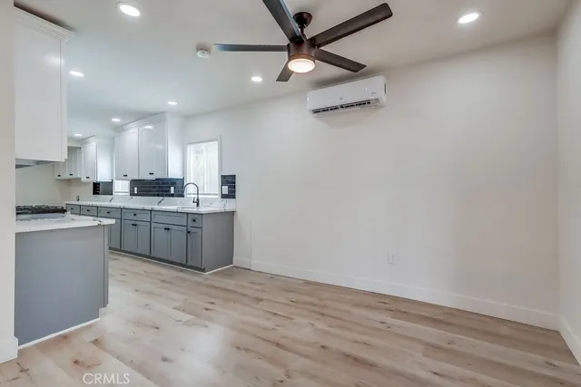 a kitchen with a sink cabinets and window