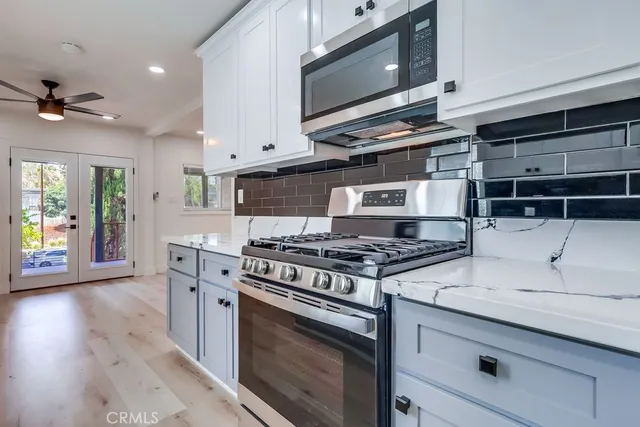a kitchen with stainless steel appliances a stove a microwave and cabinets