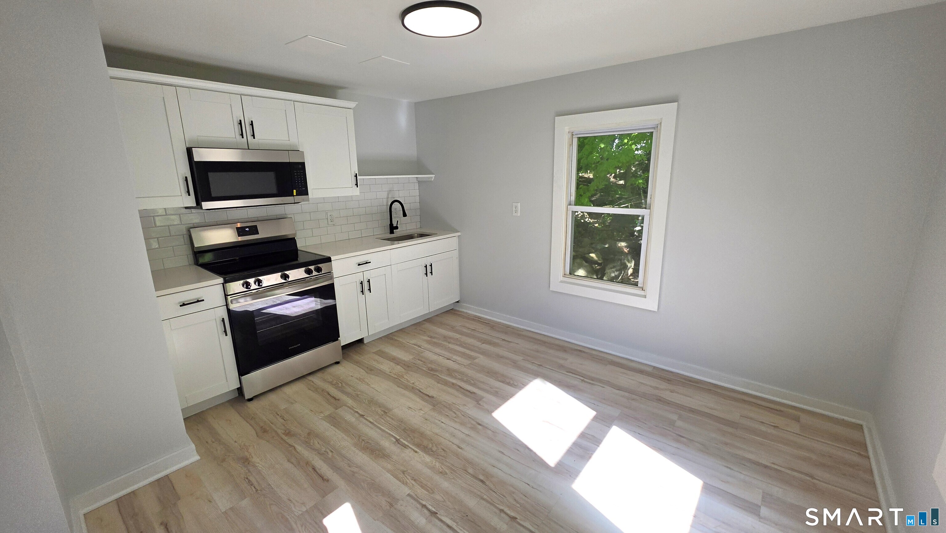 2 Maria Hotchkiss Road Prospect, CT 06712 - Photo 11 of 17 a kitchen with granite countertop a stove a microwave a sink and a refrigerator