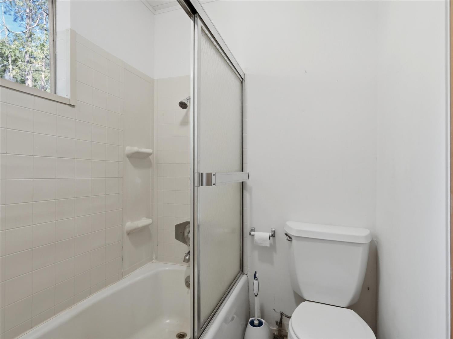 45167 Tolladay Road Oakhurst, CA 93644 - Photo 15 of 50 a white toilet sitting next to a bath tub
