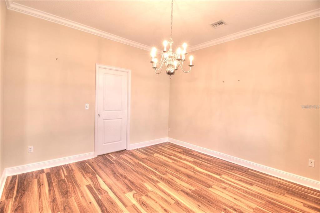 1922 Southeast 29th Street Ocala, FL 34471 - Photo 11 of 29 a view of a room with wooden floor and ceiling fan
