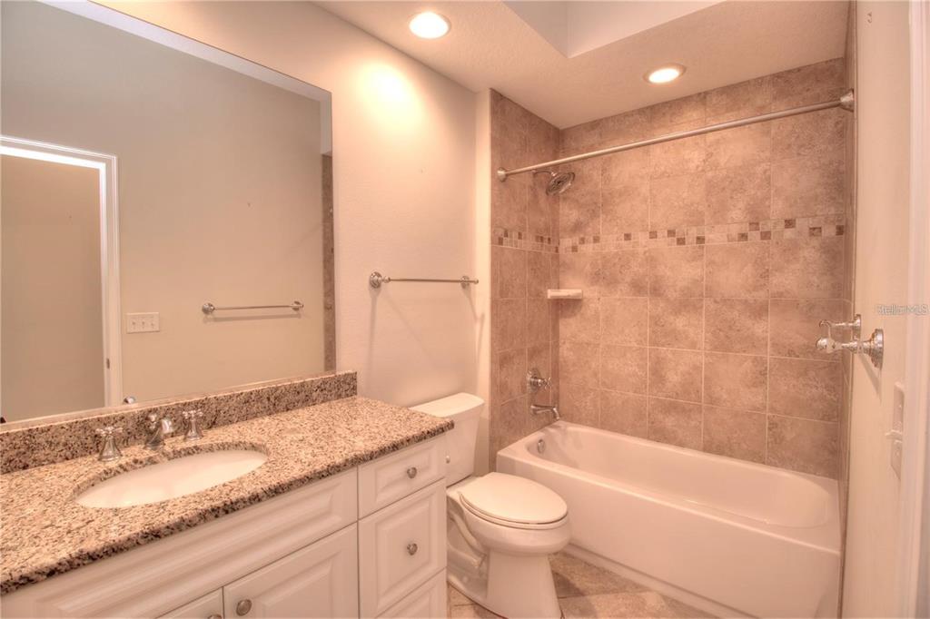 1922 Southeast 29th Street Ocala, FL 34471 - Photo 21 of 29 a bathroom with a granite countertop sink toilet and shower