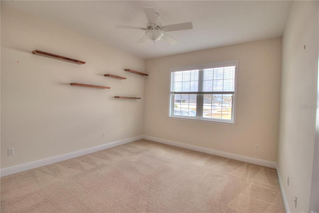 1922 Southeast 29th Street Ocala, FL 34471 - Photo 23 of 29 an empty room with a window and a ceiling fan