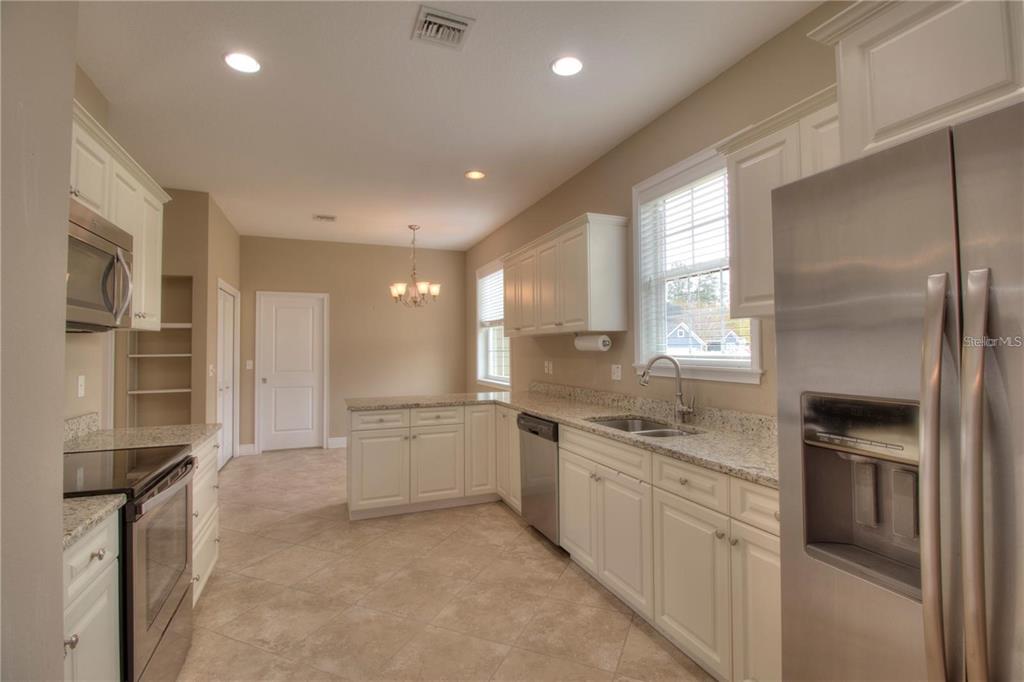 1922 Southeast 29th Street Ocala, FL 34471 - Photo 7 of 29 a kitchen with a sink stainless steel appliances and cabinets
