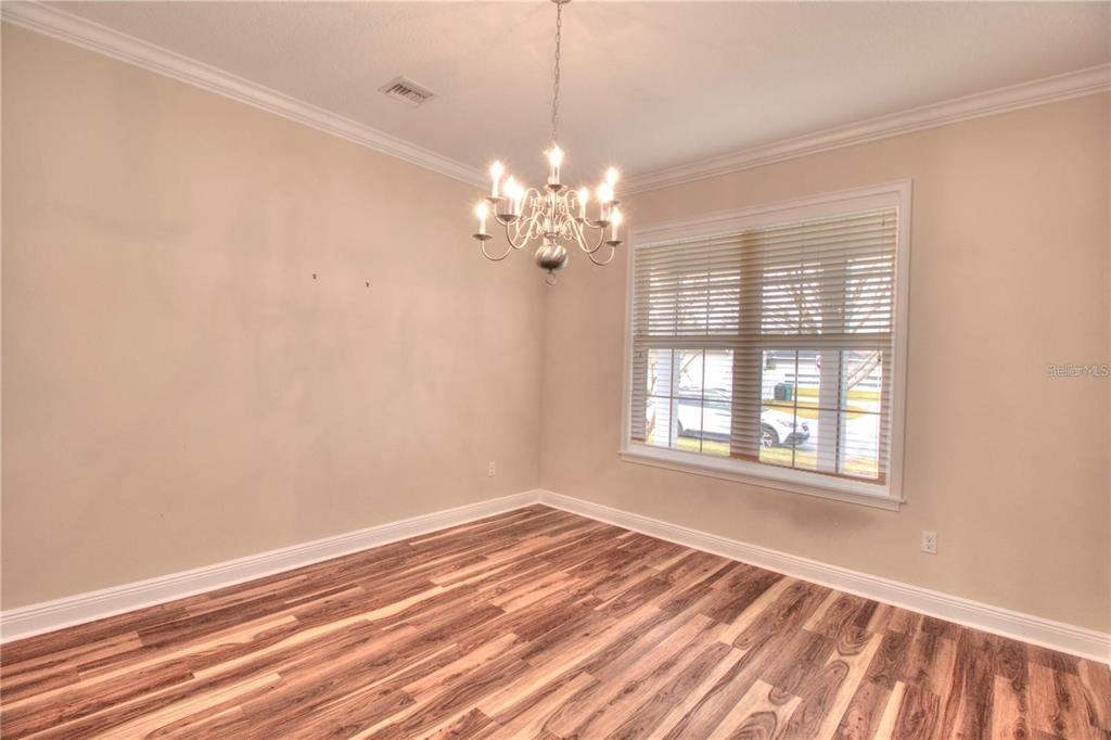 1922 Southeast 29th Street Ocala, FL 34471 - Photo 10 of 29 wooden floor in an empty room with a window