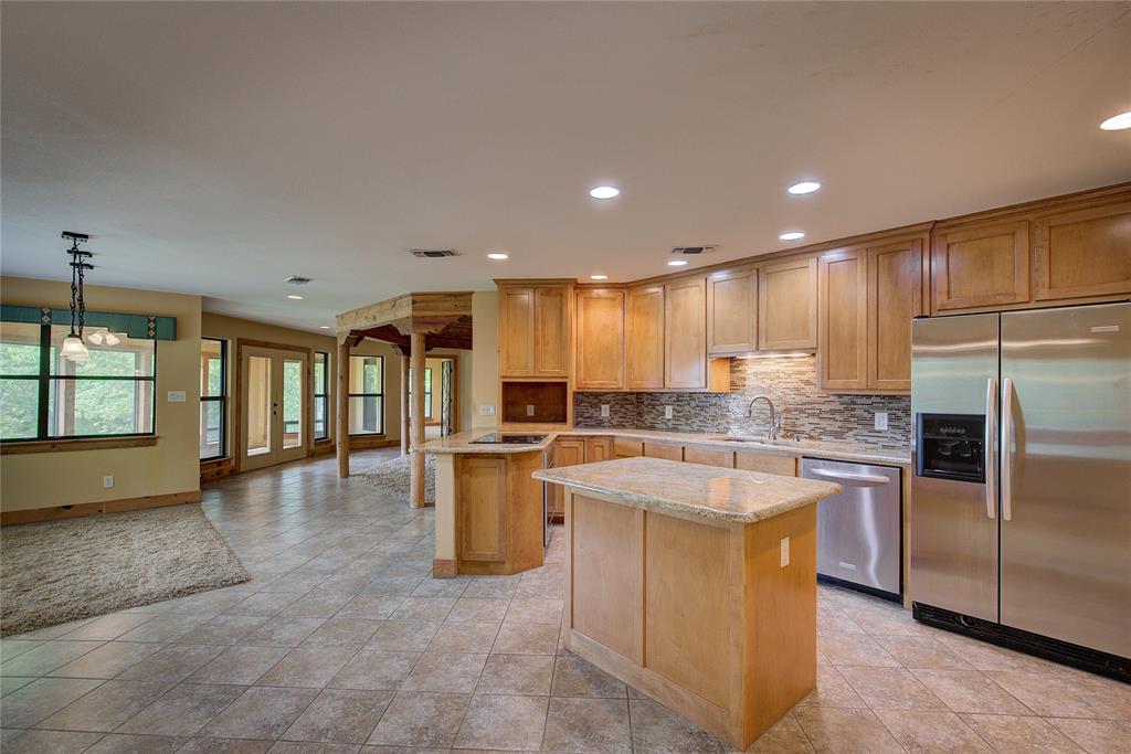 1920 County Rd SE 3370 Winnsboro, TX 75494 - Photo 12 of 40 a kitchen with a refrigerator and a sink