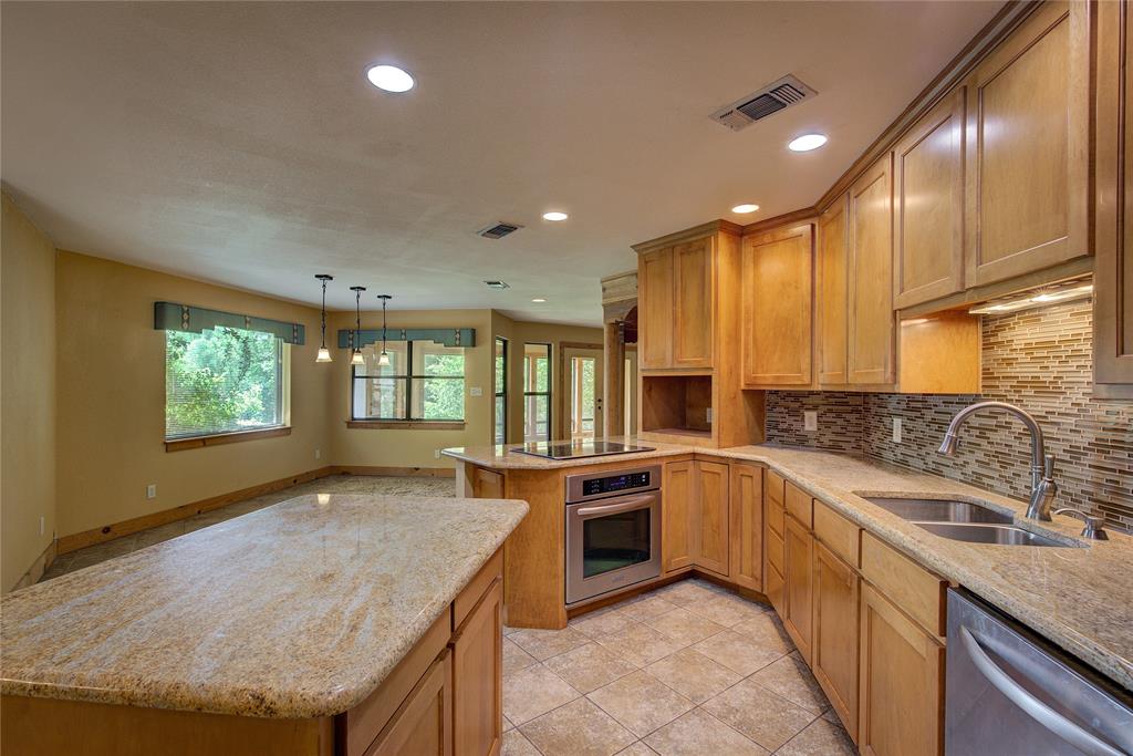 1920 County Rd SE 3370 Winnsboro, TX 75494 - Photo 13 of 40 a kitchen with a sink stove and cabinets