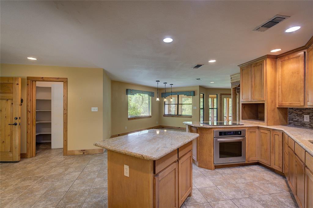 1920 County Rd SE 3370 Winnsboro, TX 75494 - Photo 14 of 40 a kitchen with stainless steel appliances granite countertop a stove and a sink