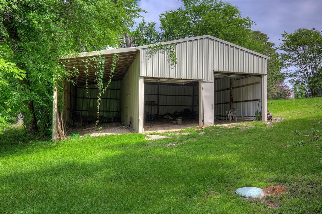 1920 County Rd SE 3370 Winnsboro, TX 75494 - Photo 33 of 40 a view of a small house with a backyard
