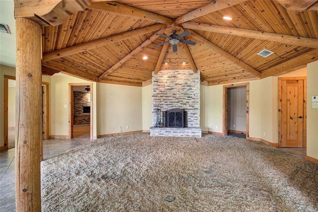1920 County Rd SE 3370 Winnsboro, TX 75494 - Photo 5 of 40 a view of an empty room with a fireplace