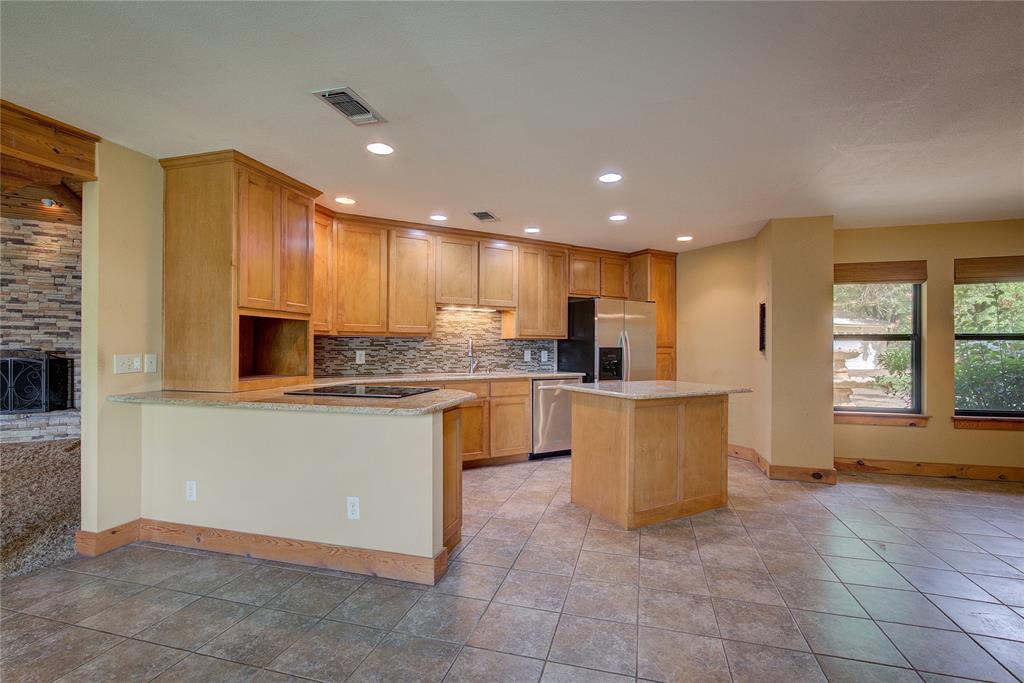 1920 County Rd SE 3370 Winnsboro, TX 75494 - Photo 10 of 40 a kitchen with a refrigerator and a sink