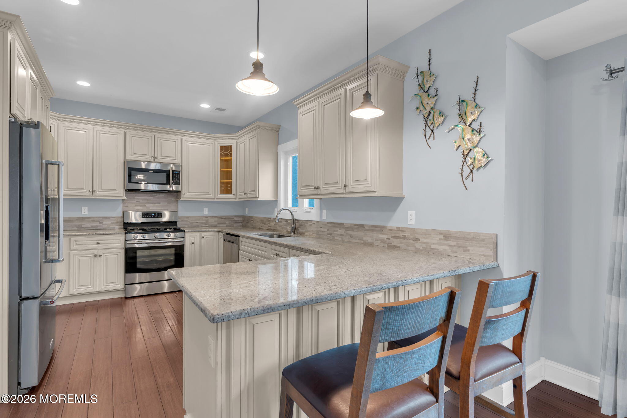 4 Conor Court Bayville, NJ 08721 - Photo 33 of 45 a kitchen with granite countertop kitchen island stainless steel appliances a stove a refrigerator a sink a dining table and chairs with wooden floor