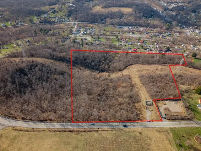 a view of a lake in middle of a field