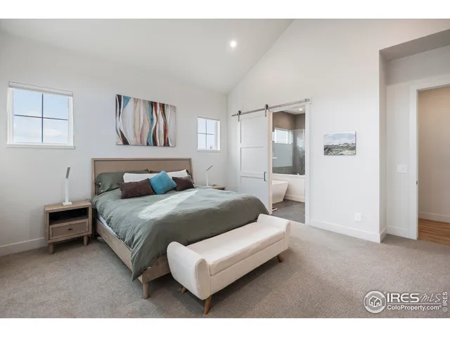 a bedroom with a bed and a night stand