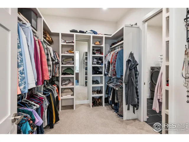 a view of walk in closet with clothes