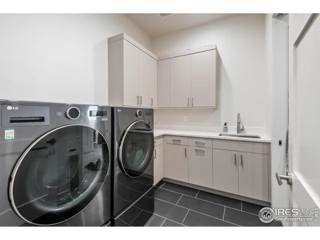 a utility room with sink dryer and washer