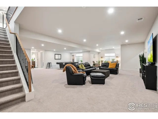 a living room with furniture a couch and a chandelier