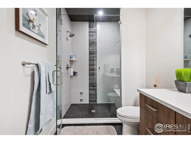 a bathroom with a toilet a sink and shower