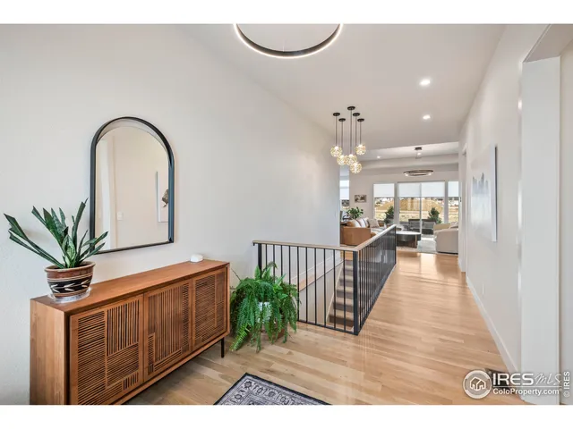 a hallway with a potted plant on a table and a potted plant