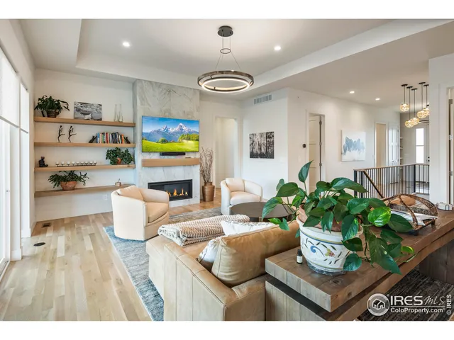 a living room with fireplace furniture and a flat screen tv
