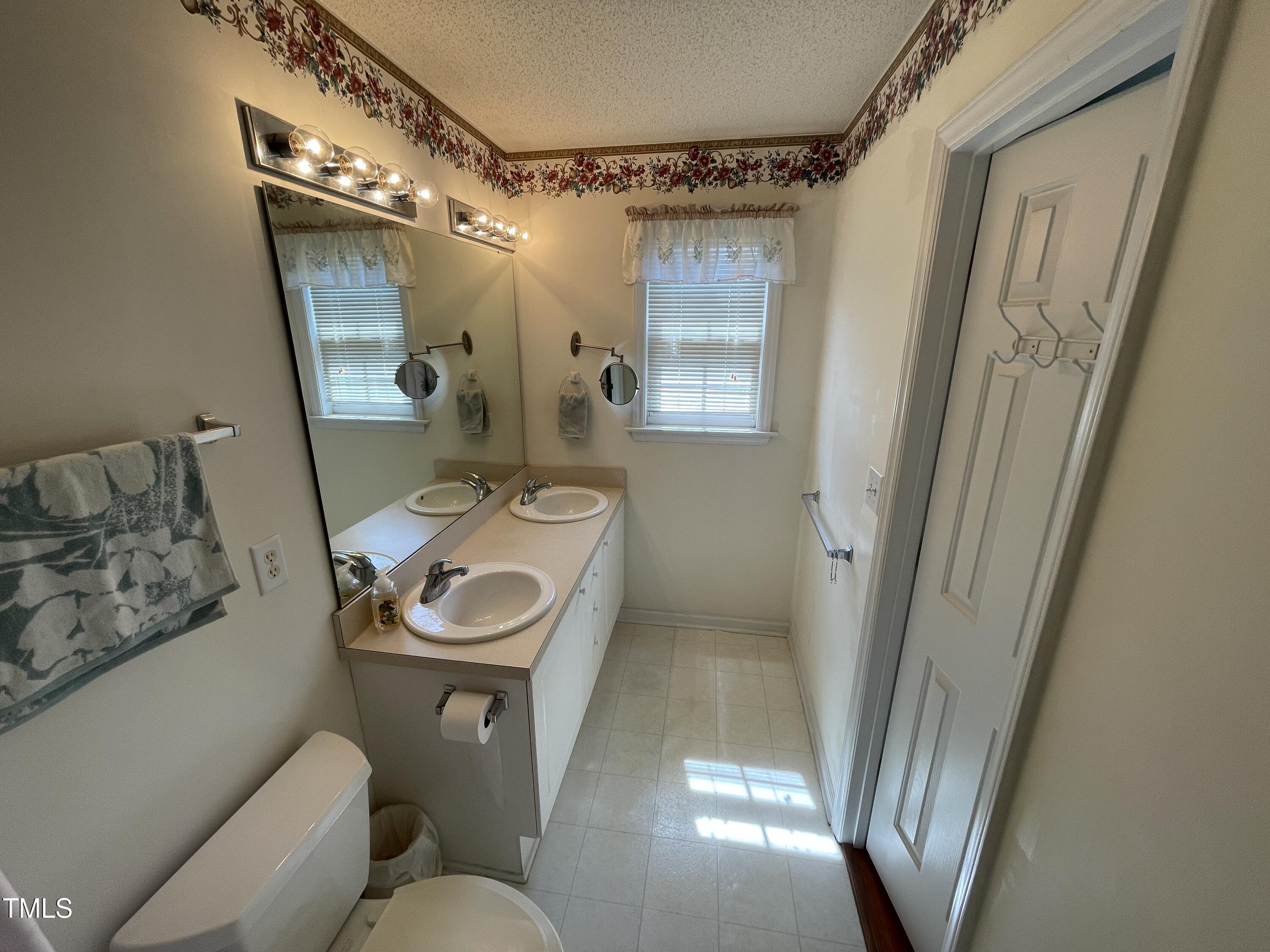2041 Metacomet Way Raleigh, NC 27604 - Photo 32 of 67 a bathroom with a toilet sink and mirror