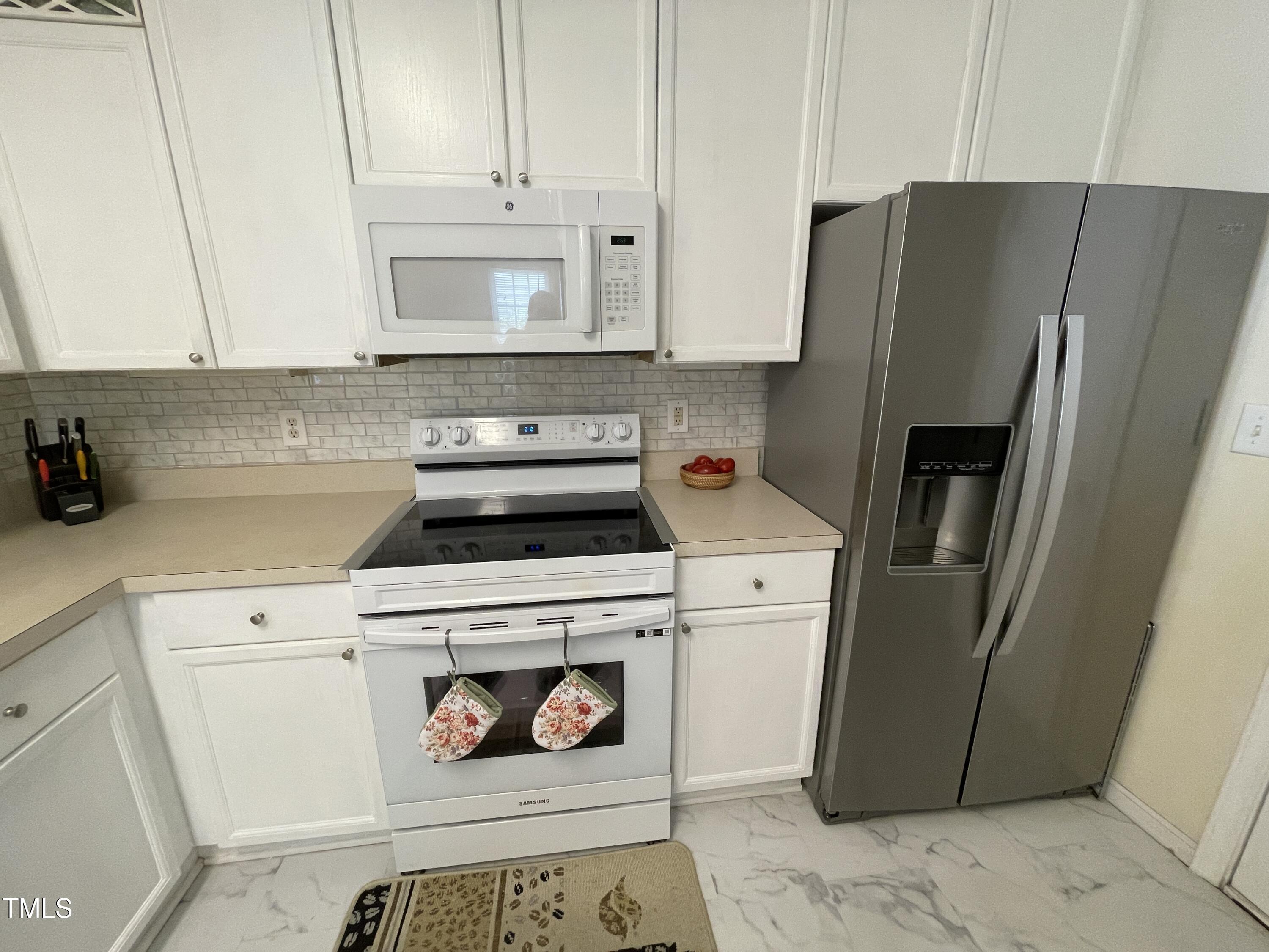 2041 Metacomet Way Raleigh, NC 27604 - Photo 6 of 67 a kitchen with a refrigerator sink and cabinets
