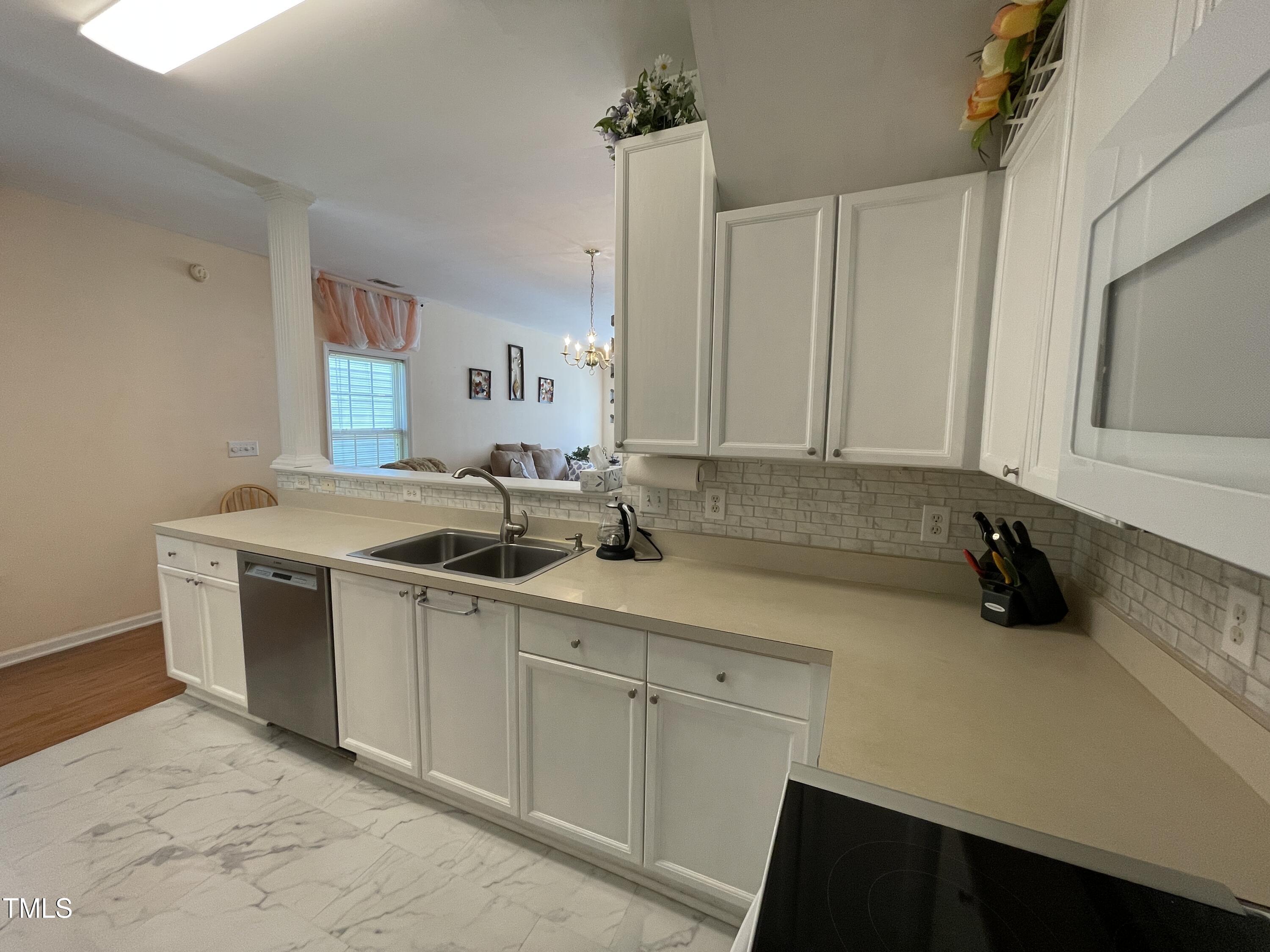 2041 Metacomet Way Raleigh, NC 27604 - Photo 7 of 67 a kitchen with a sink cabinets and stainless steel appliances