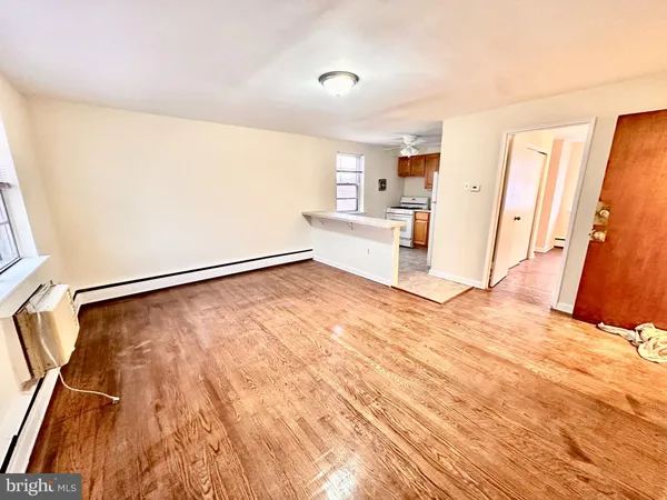 a view of a kitchen with wooden floor and a refrigerator