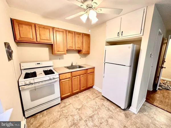 a kitchen with a refrigerator a stove a microwave and cabinets