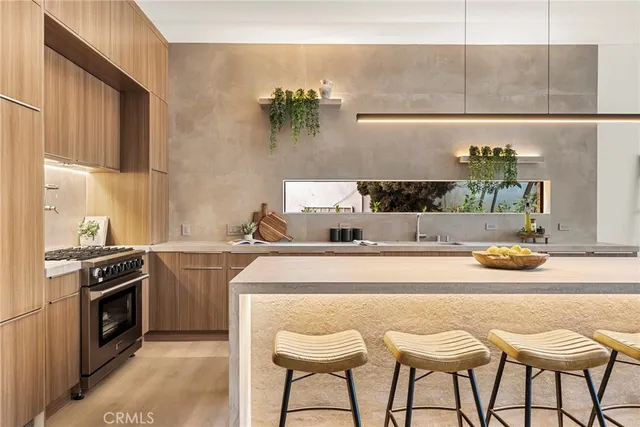a view of a kitchen with kitchen island a large window in it