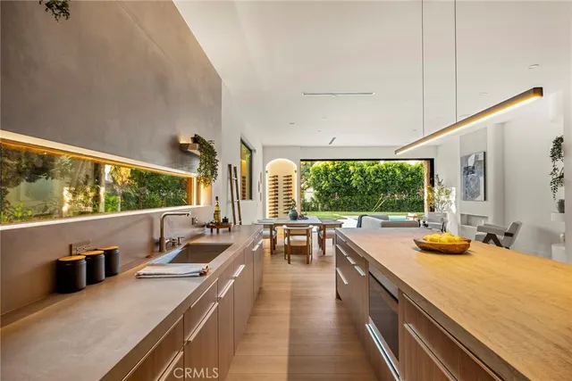 a living room with furniture a flat screen tv and kitchen view