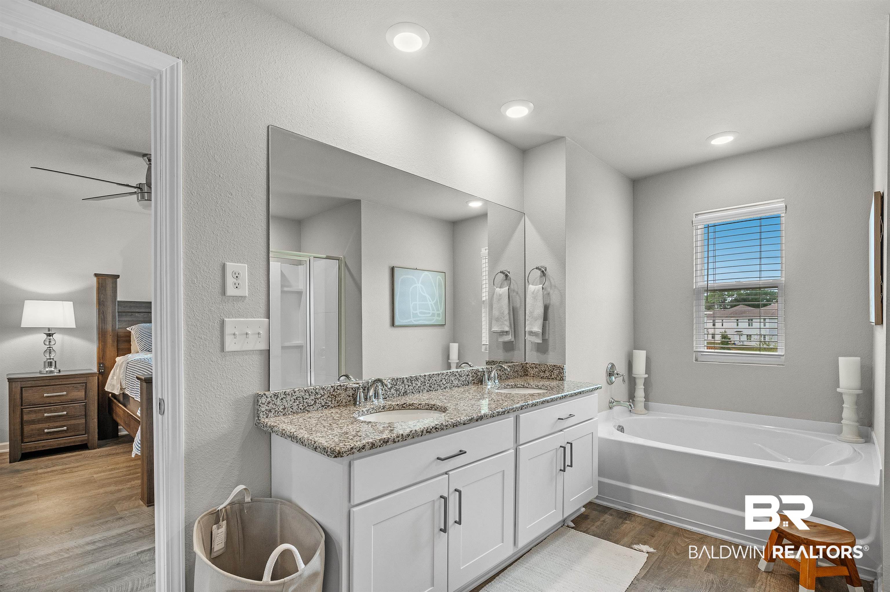 24549 Broken Sound Loop Orange Beach, AL 36561 - Photo 32 of 57 Bathroom featuring hardwood / wood-style floors, ceiling fan, vanity, and shower with separate bathtub